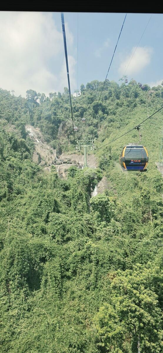 View from inside the Ba Na Hills cable car over the mountain and waterfalls