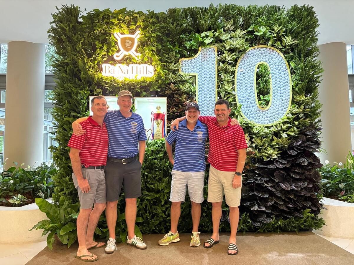 The crew celebrating with the tournament trophy in the Ba Na Hills clubhouse