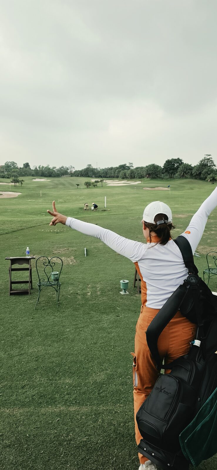 Caddie cheering on the driving range