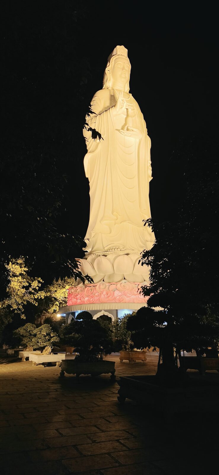 Lady Buddha statue lit up at night